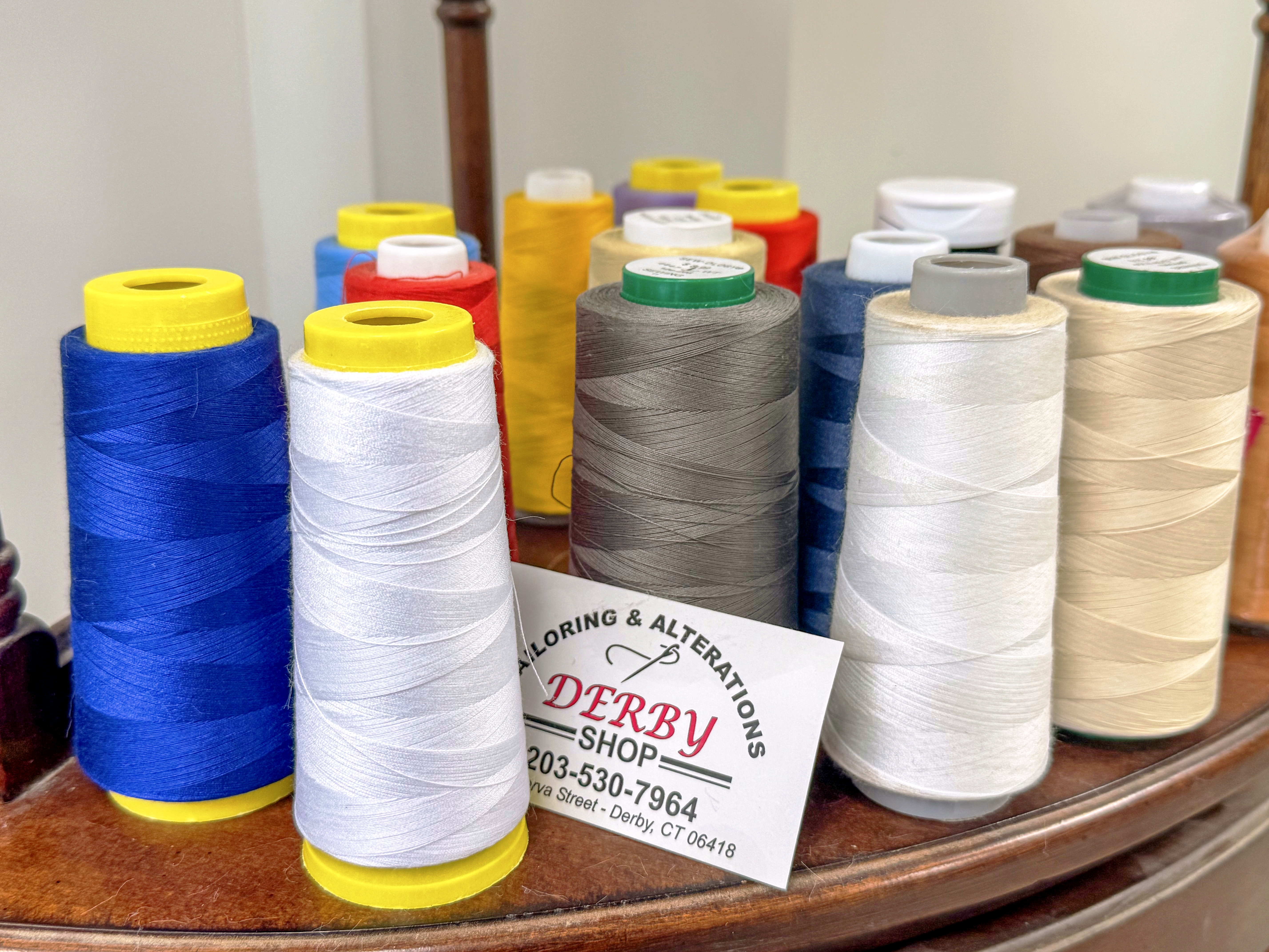 Colorful tailoring thread and Derby Shop business card